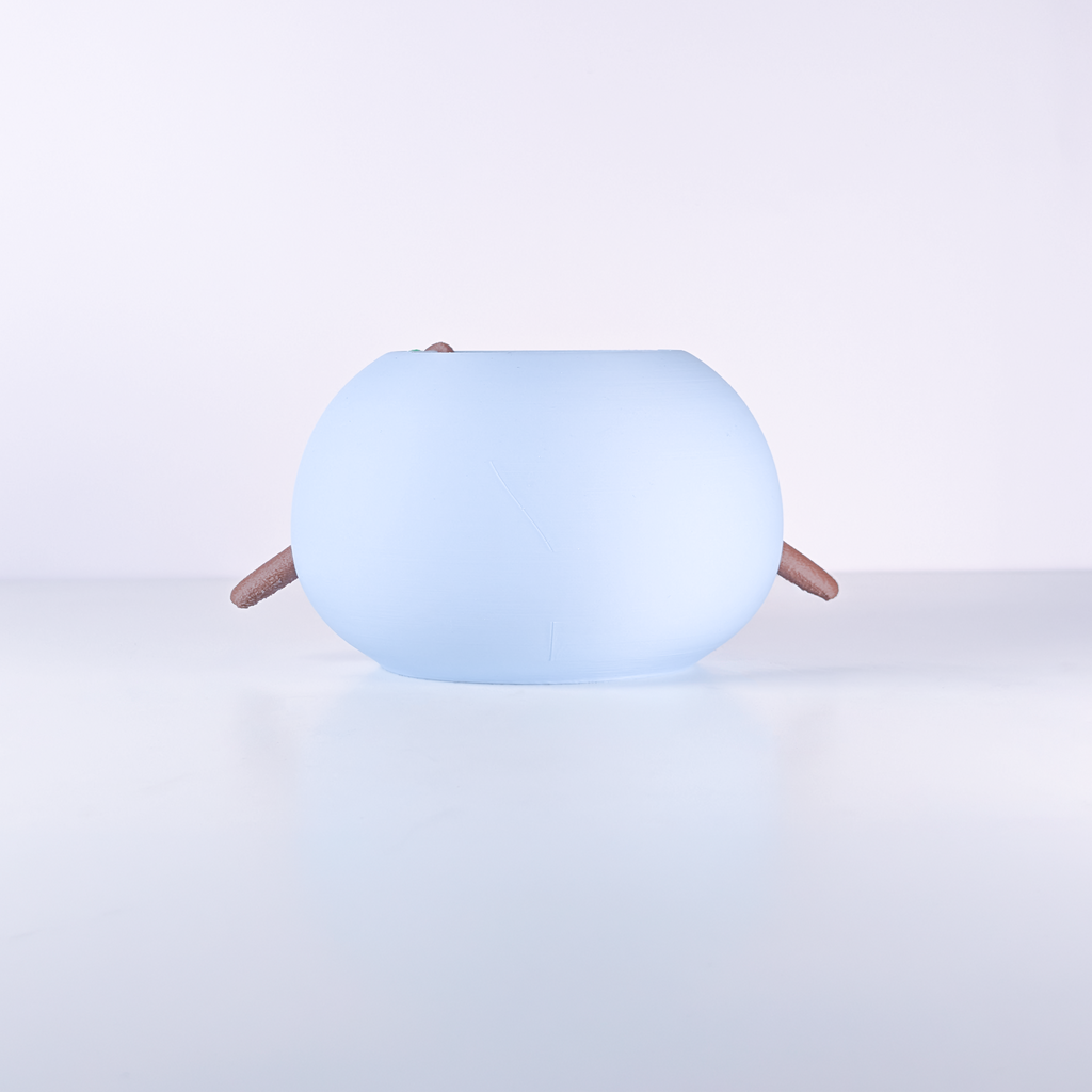 A light blue, rounded, egg-shaped device with small brown legs, photographed on a clean white studio background.