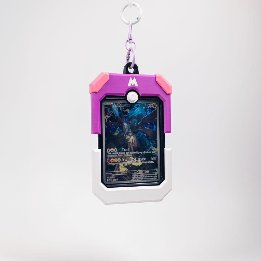A Pokémon-themed card holder keychain featuring a Magcargo design in pink and purple, holding a holographic Pokémon TCG card, suspended from a silver key ring against a light gray background.