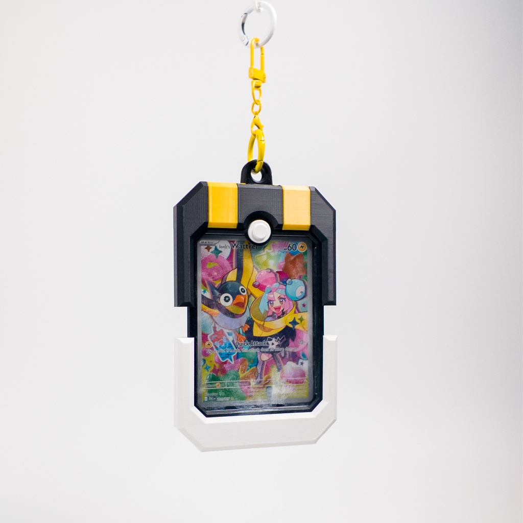 A Pokémon-themed card holder keychain featuring a colorful Lavender and Misty character card inside a black and yellow protective frame, suspended from a yellow keychain ring on a light gray background.