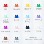 A grid of cat-shaped color options labeled with names such as RED, ORANGE, YELLOW, GREEN, LIGHT GREEN, BLUE, LIGHT BLUE, PURPLE, MAGENTA, PINK, BLACK, WHITE, BROWN, and GREY. Text at the bottom reads 'TANOOKIE AVAILABLE COLOURS.